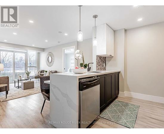 A modern kitchen with a large island and a dining area.