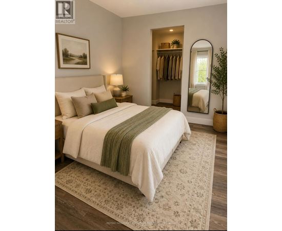 A bedroom with a large bed and a mirror on the wall.