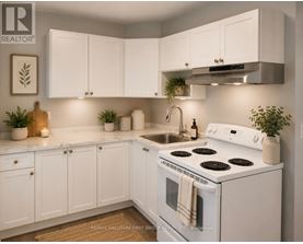 A white kitchen with a stove, sink, and cabinets.