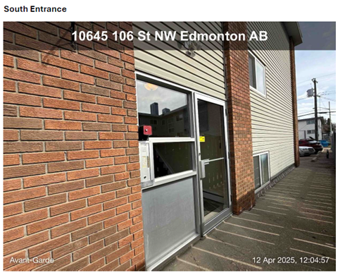 A building with a south entrance and a brick wall.