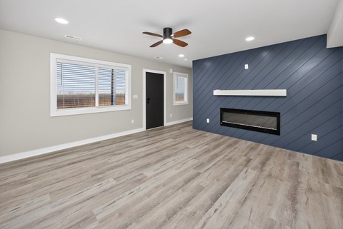 A room with a fireplace and a ceiling fan.