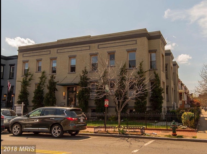 A building with a tree in front of it.