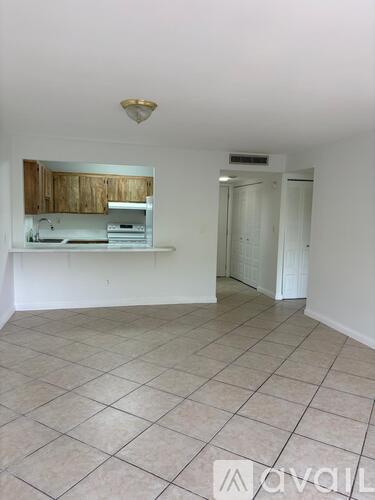 A kitchen area with a counter and cabinets.