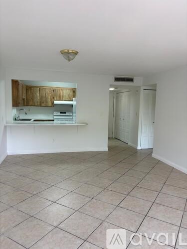 A kitchen area with a counter and cabinets.