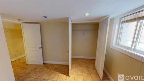 A room with a tiled floor and a window on the right side.