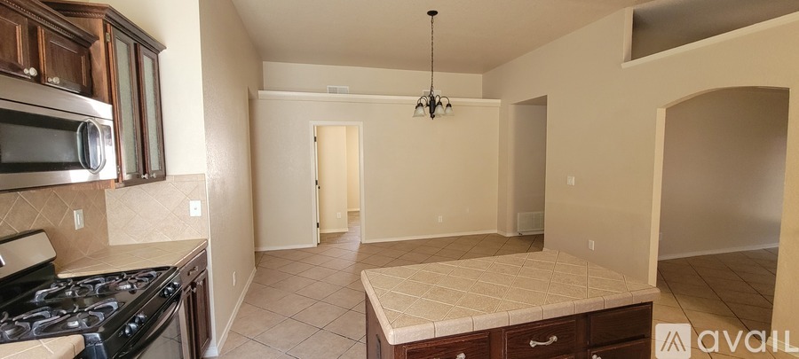 A kitchen with a black stove top oven and a black microwave.