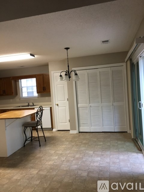 A kitchen with a table and chairs in it.