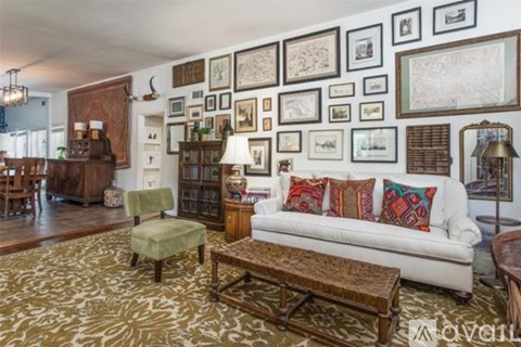 A living room with a white couch and a coffee table.
