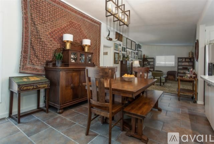 A dining room with a wooden table and chairs.