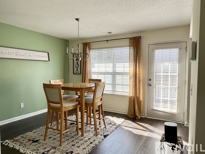A dining room with a table and chairs.