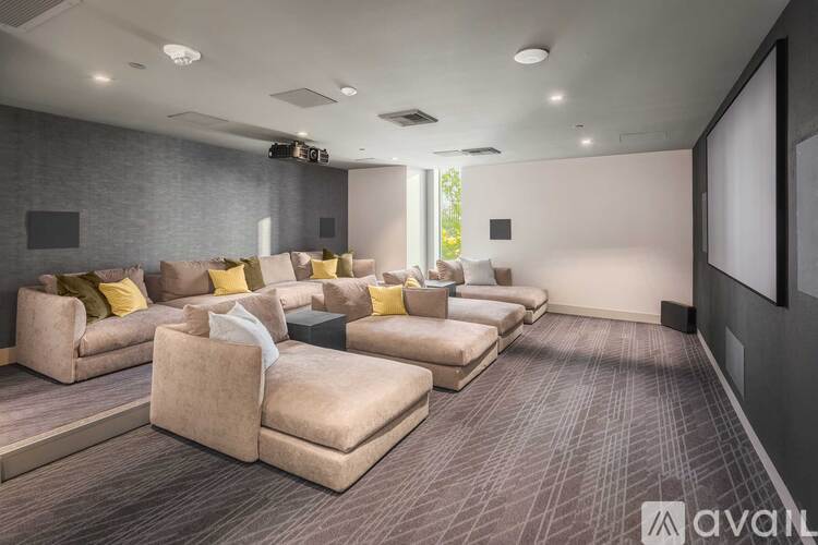 A living room with a row of couches and a television.