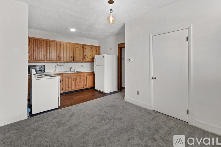 A kitchen with wooden cabinets and white appliances.