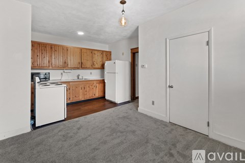 A kitchen with wooden cabinets and white appliances.