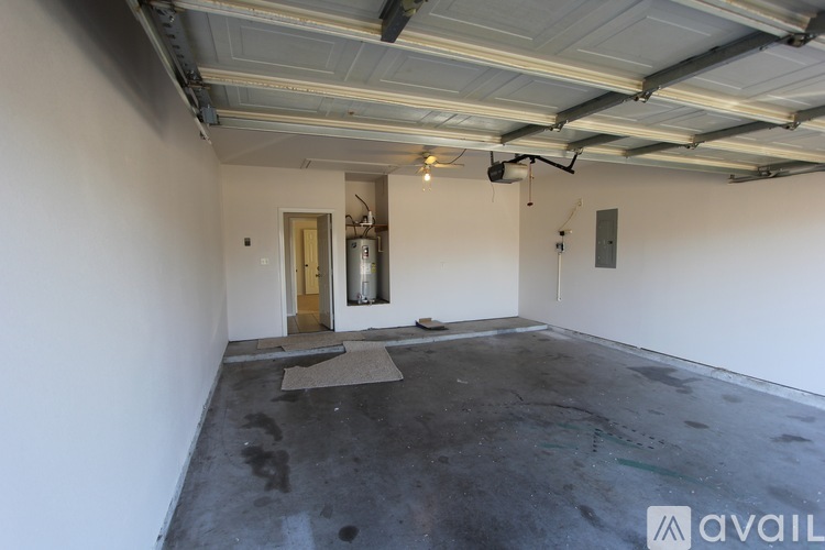 A spacious garage with a door and a mat on the floor.