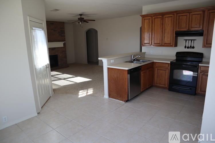 A kitchen with a white counter top and wooden cabinets.