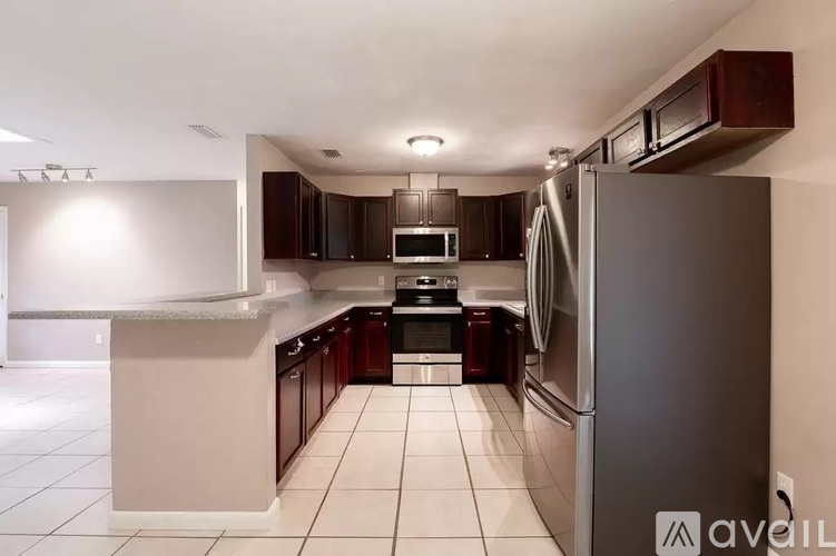 A modern kitchen with a refrigerator on the right.