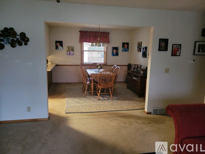 A living room with a dining table and chairs.