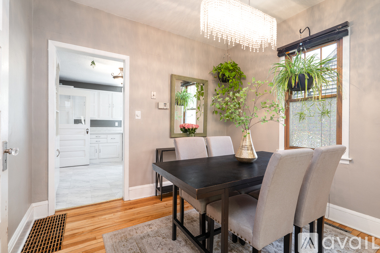 A dining room with a table and chairs.