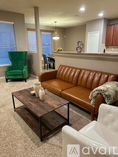 A living room with a brown leather couch and a wooden coffee table.