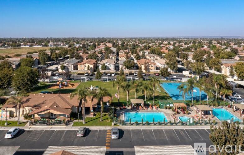 A bird's eye view of a residential area with a swimming pool.
