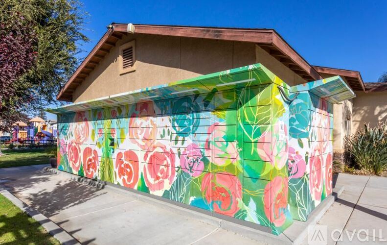A house with a wall painted with colorful roses.