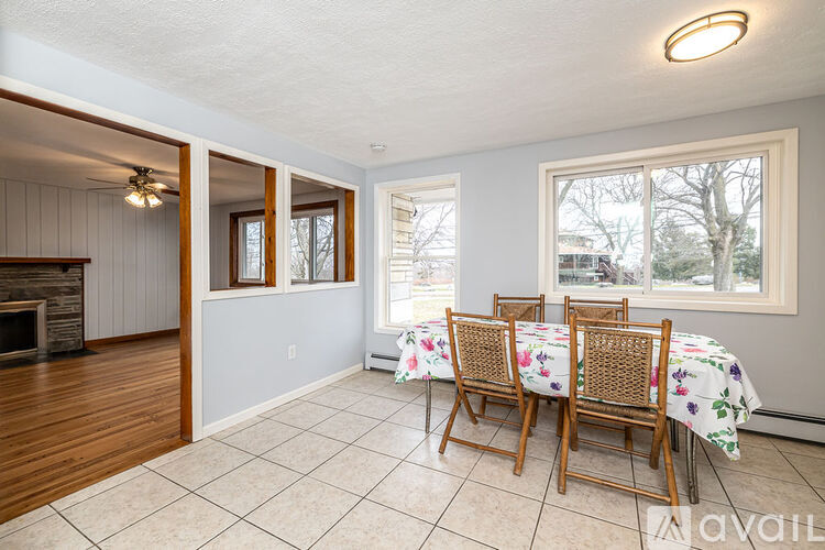 A dining room with a table set for four.