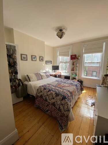 A bedroom with a bed and a window.