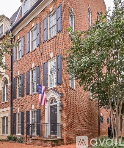 A brick building with a flag on the front.