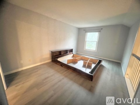 A living room with a fireplace and a window.