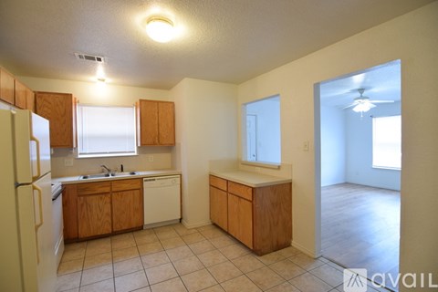 A kitchen with wooden cabinets and a white refrigerator.