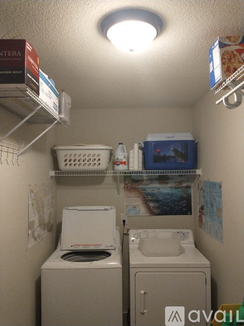 A small bathroom with a toilet, sink, and a shelf with various items.