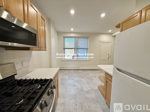 A kitchen with a stove top oven and a microwave above it.