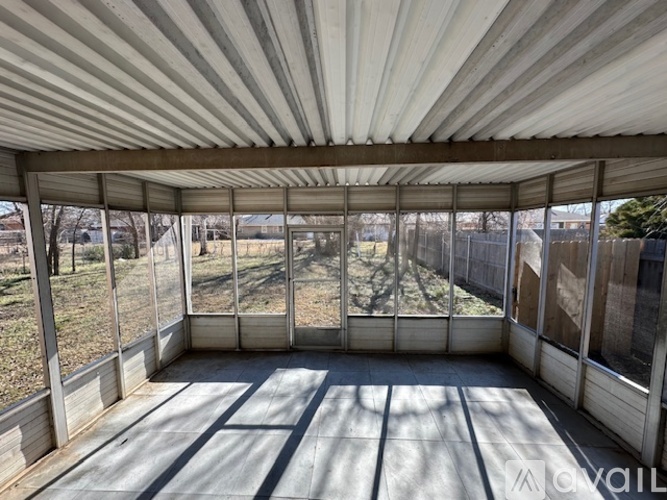 A sunny day in a spacious room with a glass wall and a wooden floor.