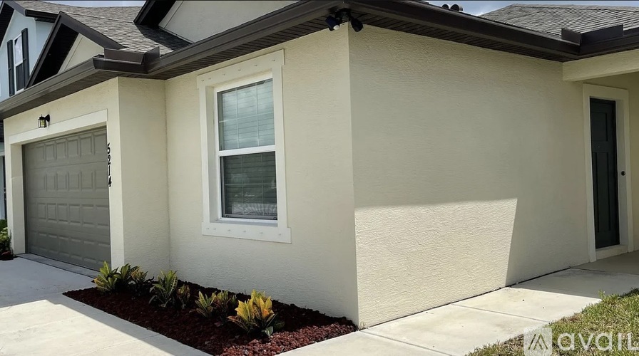 A house with a garage door and a window.