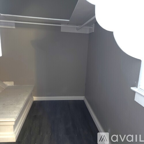 A room with a bench and a shelf on the wall.