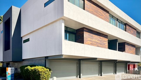 A modern building with a white facade and darker accents.