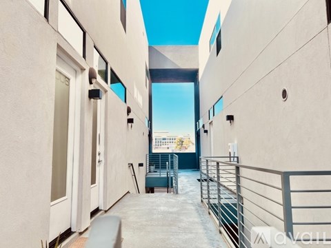 A balcony with a metal railing and a view of the city.