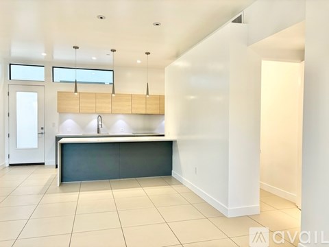 A kitchen area with a counter and cabinets.