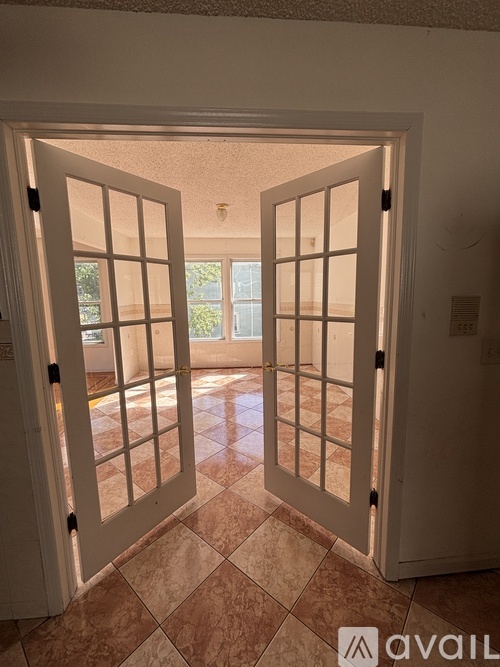 A white door with a glass window is open.