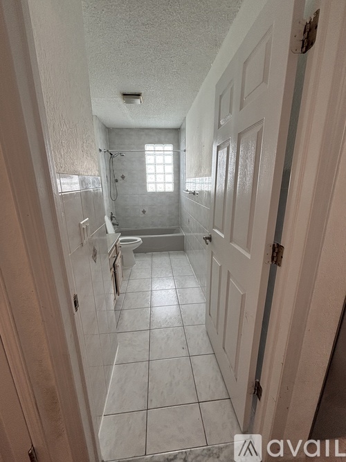 A bathroom with a toilet, sink, and shower.