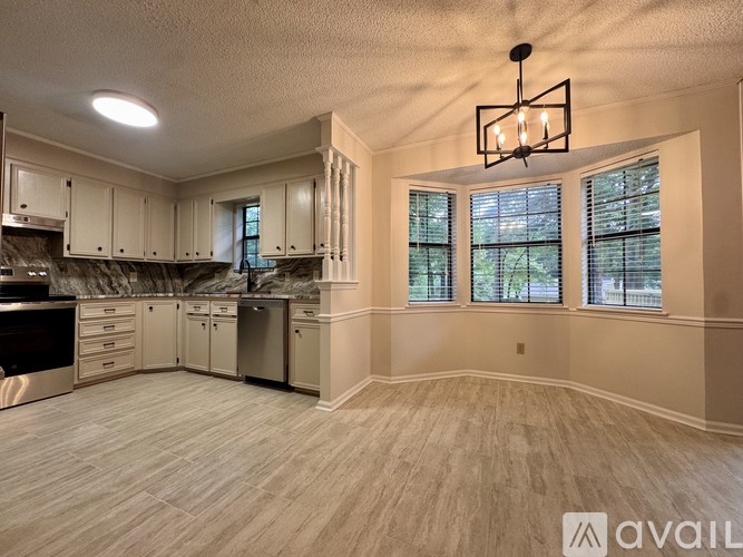 A kitchen with a large island and stainless steel appliances.