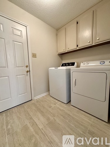A small laundry room with a washer and dryer.