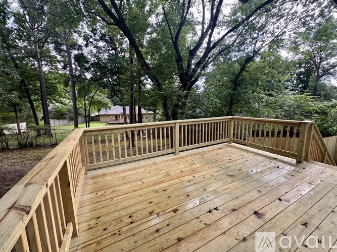 A wooden deck surrounded by trees.