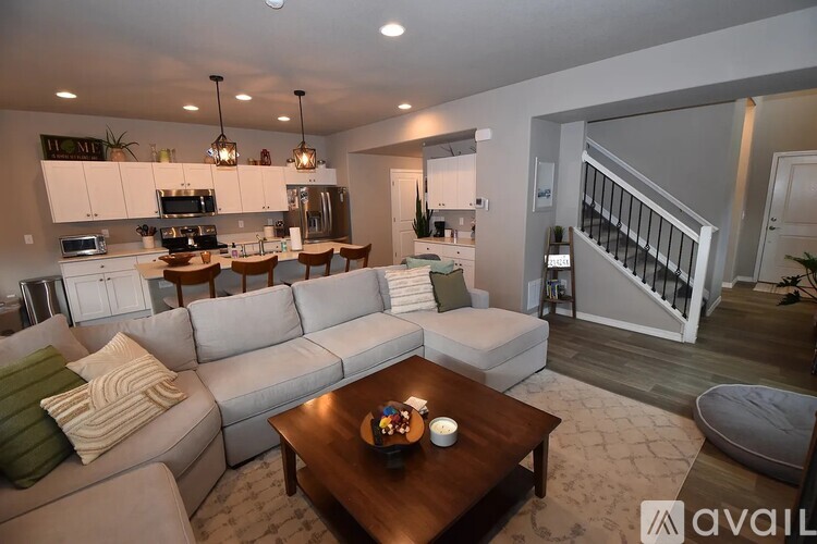 A modern living room with a grey sofa and a wooden coffee table.