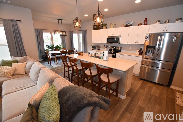 A modern kitchen with a dining table and chairs.