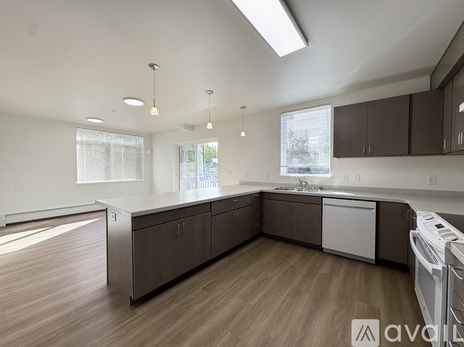 A kitchen with brown cabinets and a white countertop.