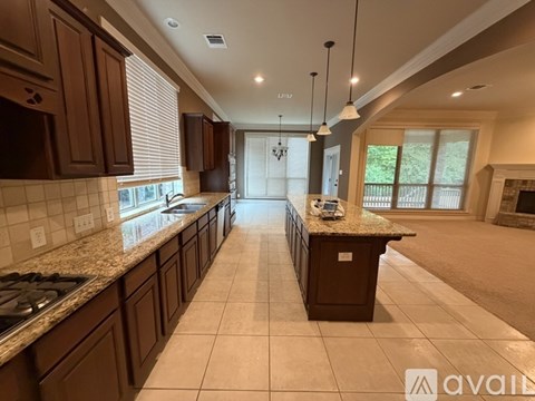 A kitchen with brown cabinets and a granite countertop.