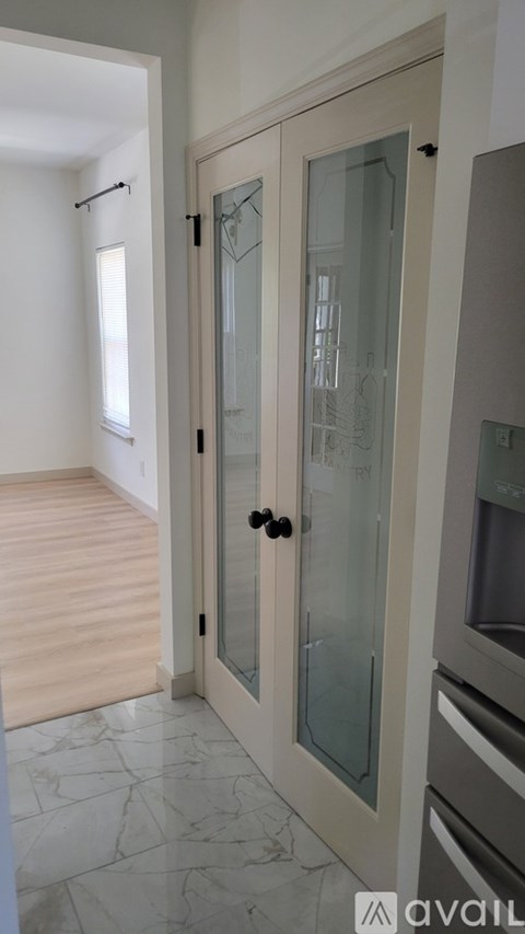 A glass door cabinet in a kitchen.