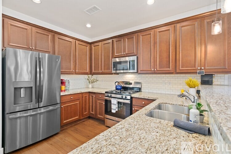 A kitchen with wooden cabinets and a granite countertop.