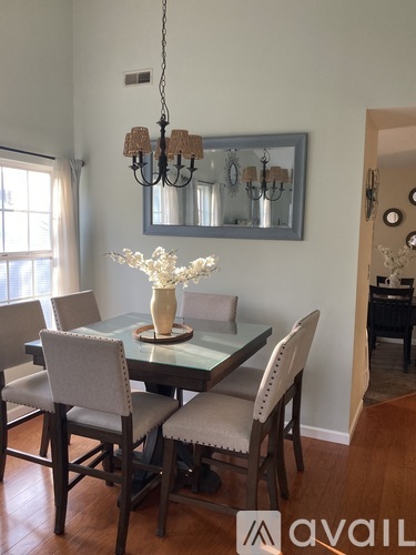 A dining room with a glass table and chairs.